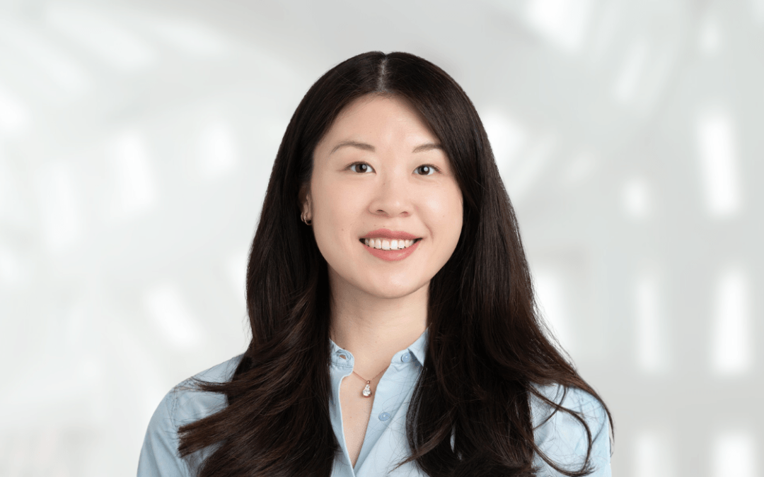 dr helen chan, an Asian-American woman with long dark hair, wearing a light blue shirt and smiling